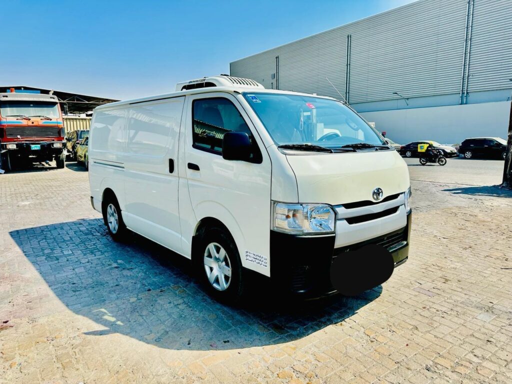 A white freezer van parked in Dubai ready for frozen food transport, with sub-zero temperature control for ice cream, meat, and frozen meals delivery.