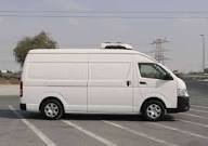 Chiller van for rent in Dubai parked outside a warehouse for refrigerated goods delivery